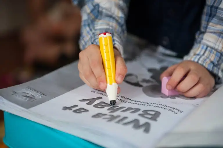 child with lego pencil