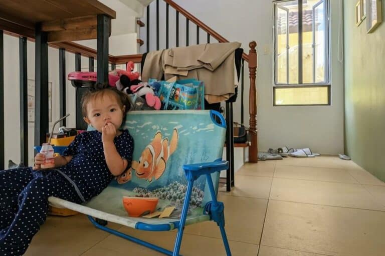 little girl on the bench having a snack