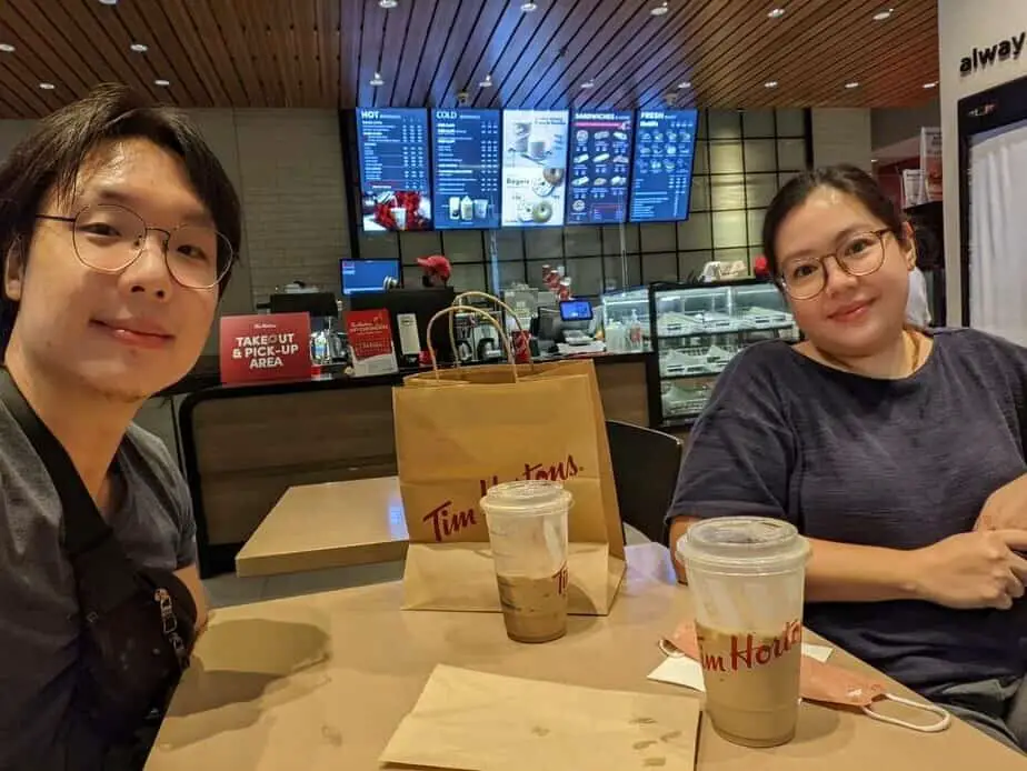 Husband and wife having coffee at Tim Horton's