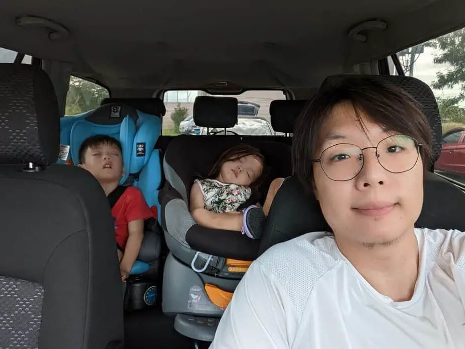 Jed Chan with sleeping kids inside the car.