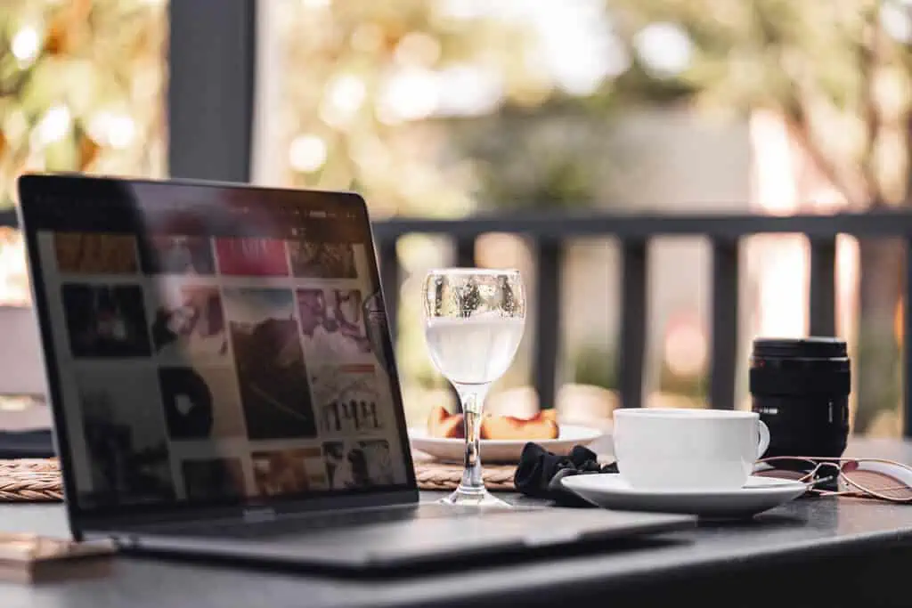 laptop with glass and coffee cup.