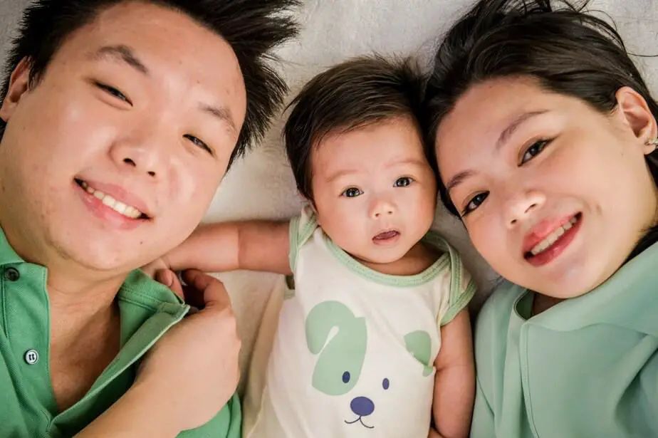 new parents and son in green.