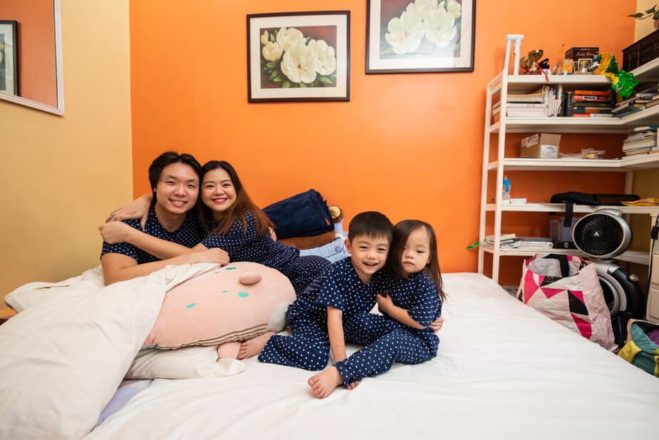 Family in bedoom with orange and yellow background.