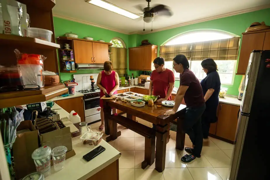 Mom cooking in a kitchen with a green background.