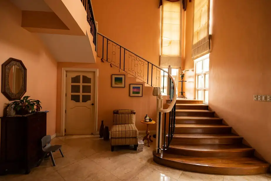 Living room with grand staircase with peace background.